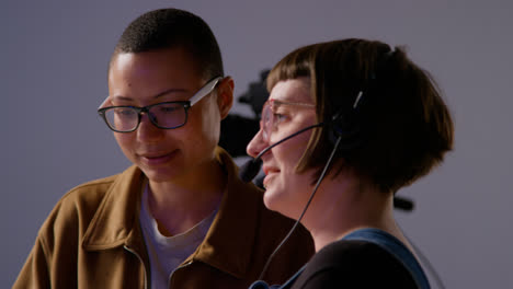 Female-Film-Director-And-Assistant-Shooting-Movie-Or-Video-Discussing-Scene-In-Studio-Shot-In-Real-Time-2